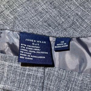 Jones wear grey suit with light navy and blue strips intertwined